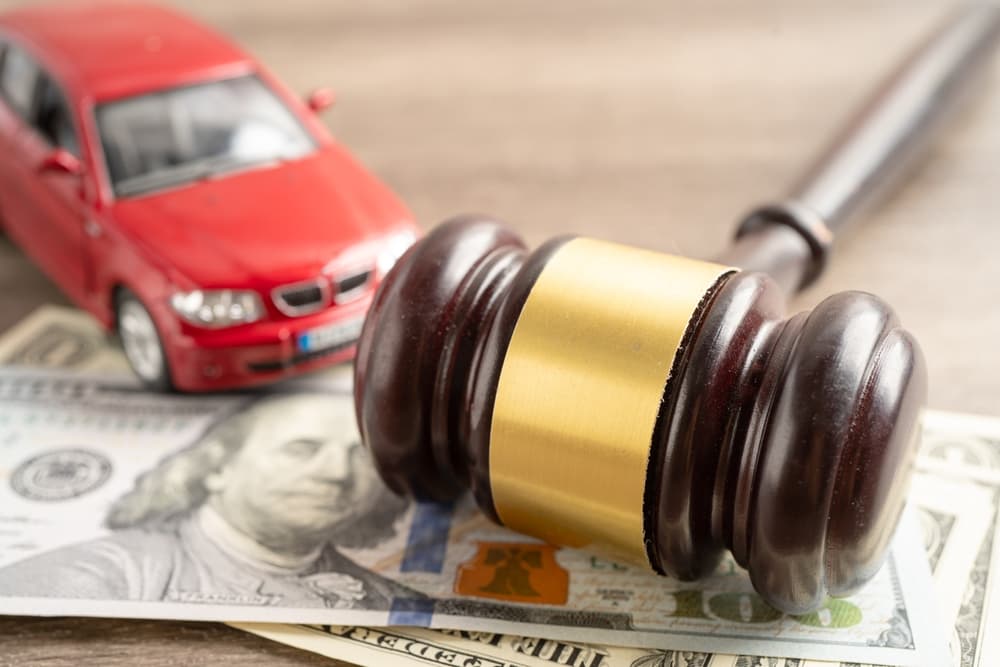 A Car, dollar bills an judge's gavel - Concept of Car accident claim