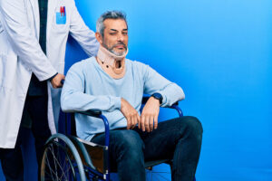 Man in wheelchair with doctor standing behind him