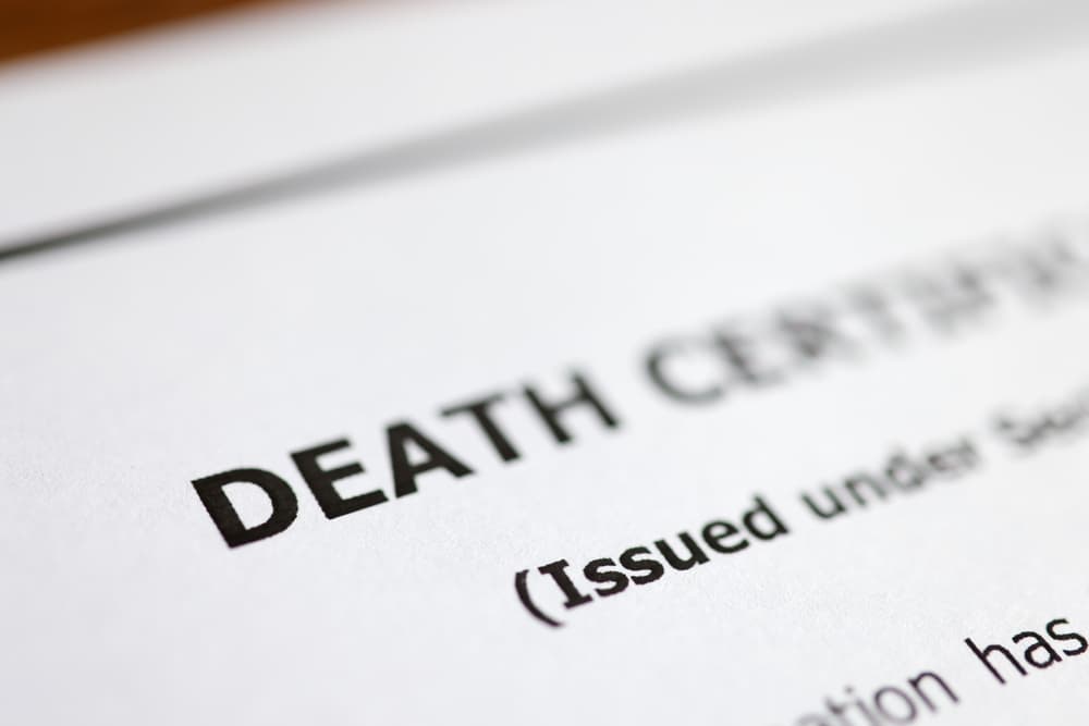 Table displays a death certificate and post-mortem paperwork for a deceased family member.