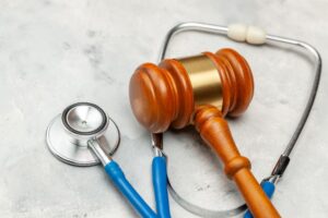 Legal and medical symbols: Gavel and stethoscope. Representing the intersection of law and medicine, addressing sentences related to medical negligence.