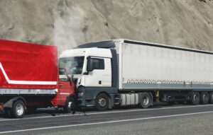 Two commercial trucks colliding on a Missouri highway showing severe front end damage representing the type of truck accident claim handled by Cook Barkett Ponder and Wolz