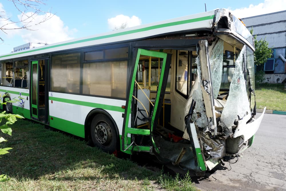 A bus broken down in a parking lot after an accident, illustrating the consequences of careless driving.