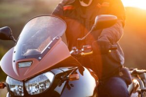 Motorbiker holding steering bar, riding in Cape Girardeau.