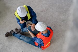 Top view of construction workers had an accident suffering misfortune physical knee injury from working at site