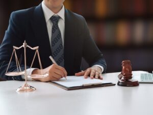 A young judge or lawyer working with documents at a table indoors.