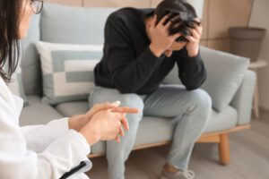 A psychologist conducting a therapy session with a patient in a comfortable office setting. 