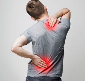 The conditions of spine osteoporosis, scoliosis, and spinal cord problems in a man's back. 