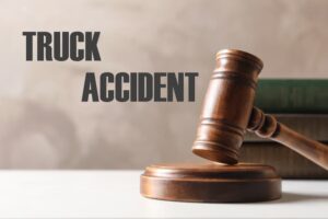 Wooden judge's gavel and legal books on a table, representing truck accident law.