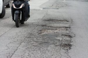 Motorcycle rider on poor road