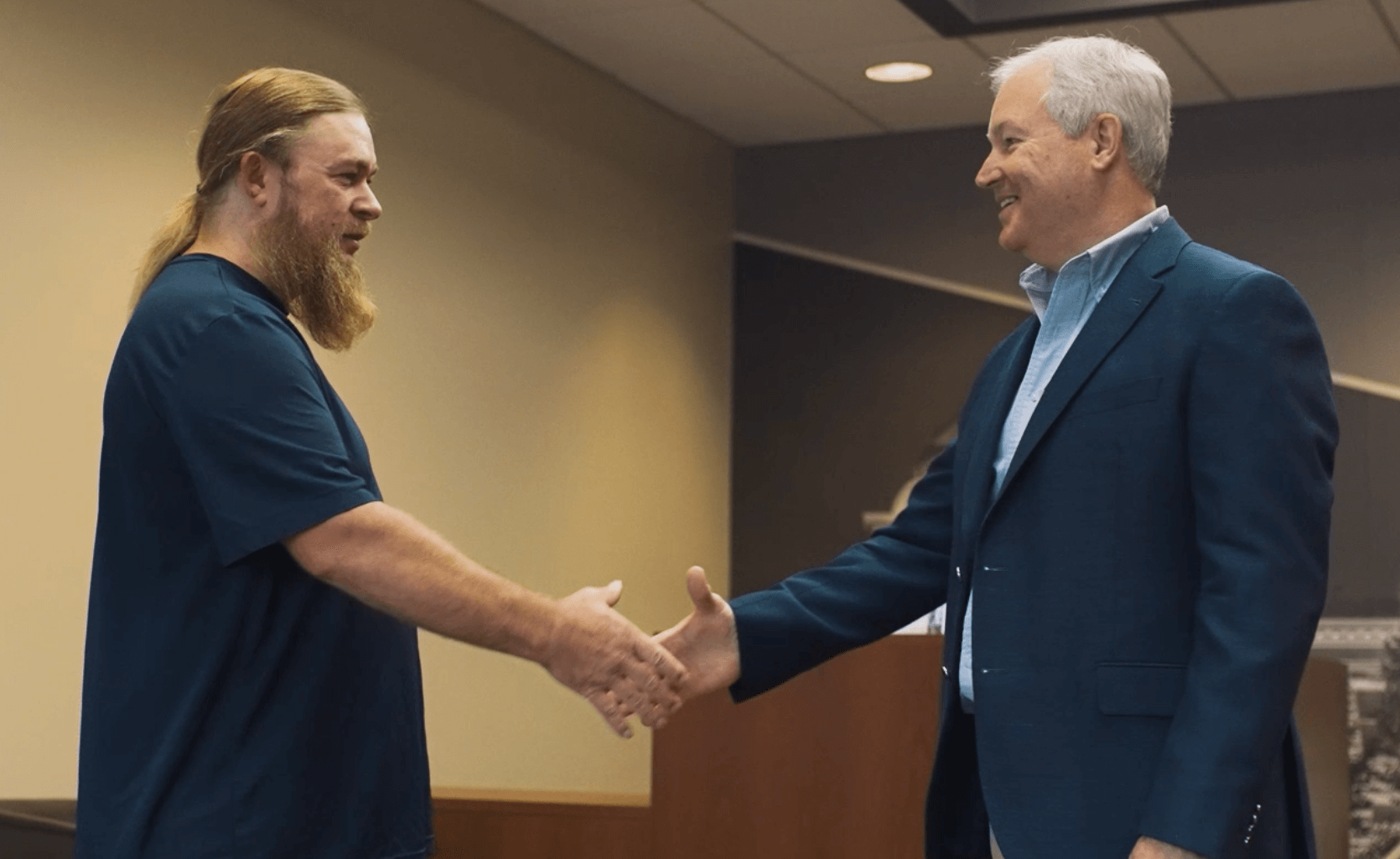 J. Michael Ponder Handshake J. Michael Ponder shaking hands with a client in his conference room