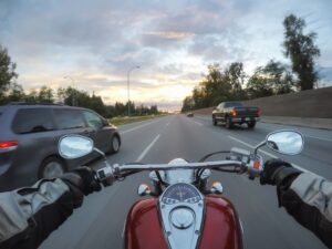 Riding a motorcycle during a vibrant sunset.