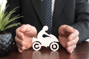 Insurer protecting a motorbike with his hands