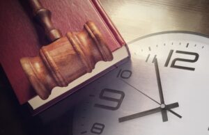 Clock with Judge's Gavel on A Book