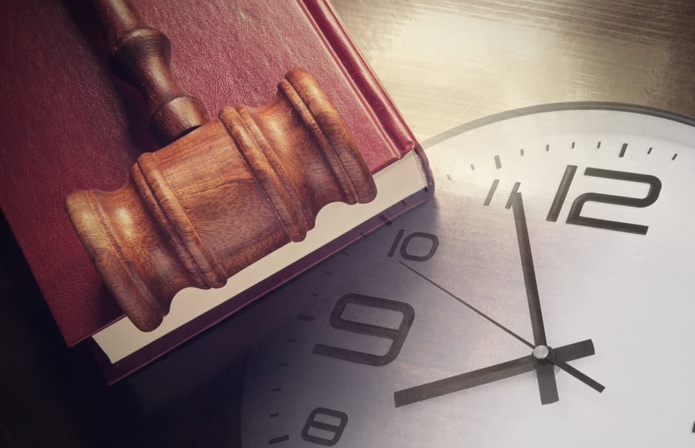 Clock with Judge's Gavel on A Book