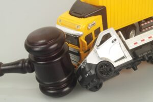 Judge gavel and container carrier hits truck on grey background. Concept of legal proceedings