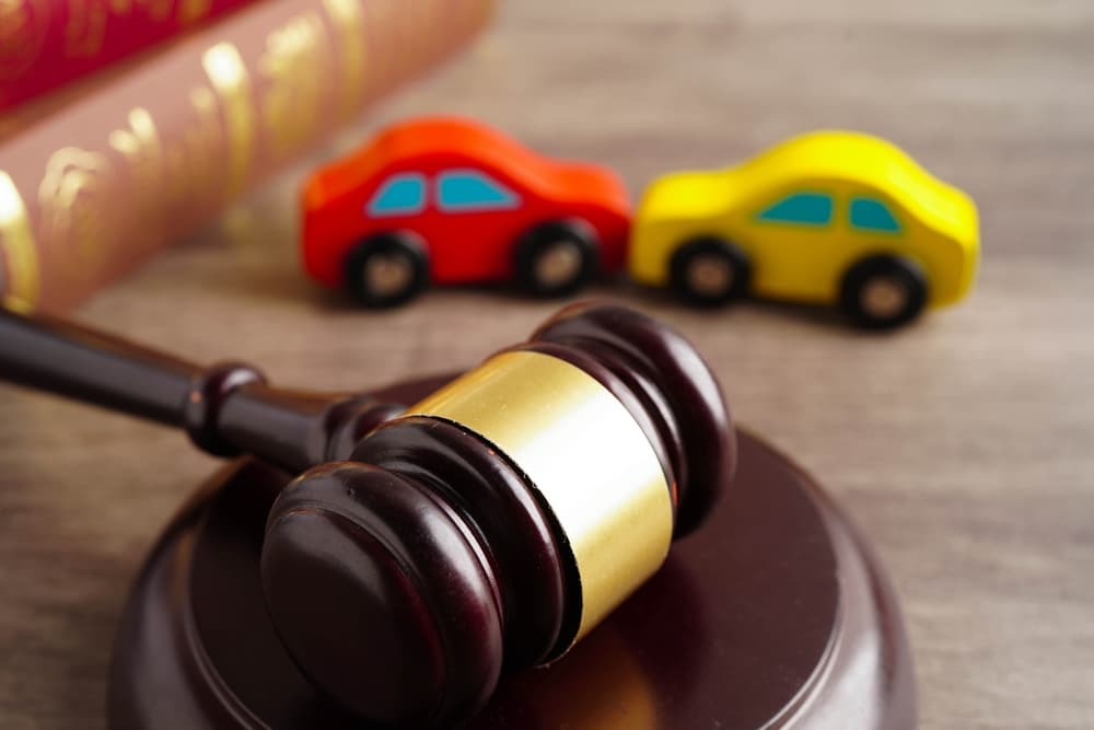 Judge's Gavel and toy accident cars in background - Concept of Car Accident Trial
