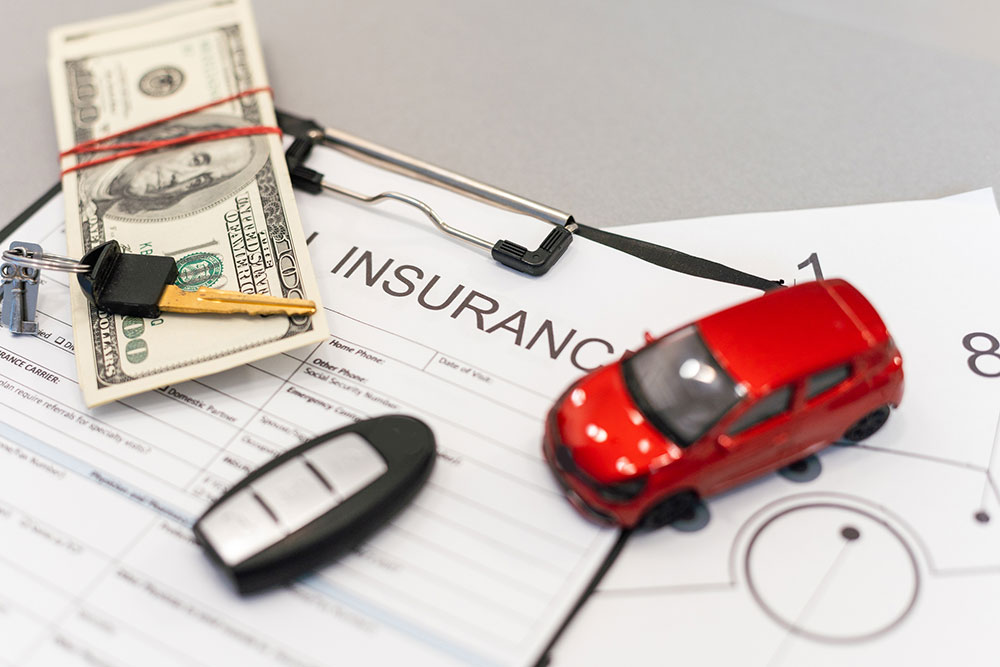 Car insurance claim form with a car key, representing filing a claim after an accident.