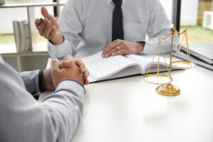 Lawyer presenting a signed document to a client with a gavel on the table, representing legal options after a truck crash.