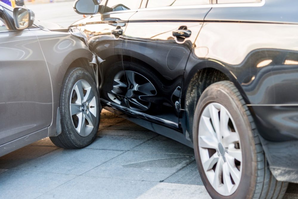 Gray sedan crashed into the side door of a black SUV in a side-impact collision